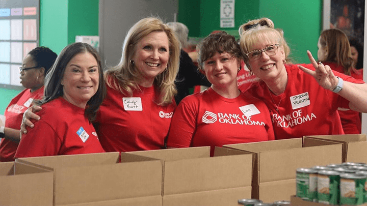 Bank of Oklahoma employees sorting canned goods at a food drive.