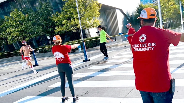 Bank of Oklahoma employee volunteers handing out water at the Oklahoma City Marathon.